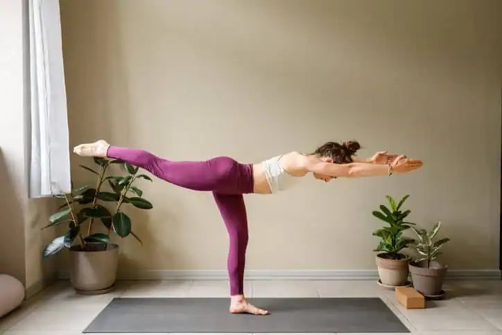 Woman doing Yoga exercise Woking to help with toning the body. 