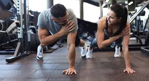 Image of man and woman doing Cardio Woking to tone their arms. 